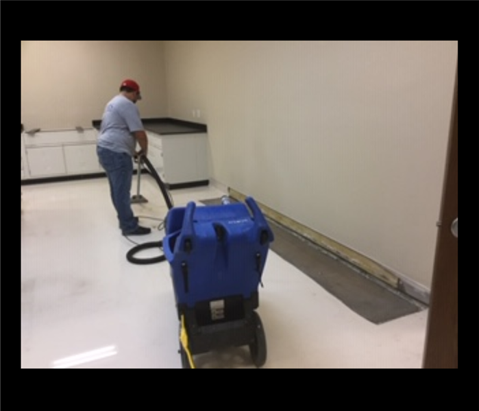Technician Extracting Water with Vacuum 