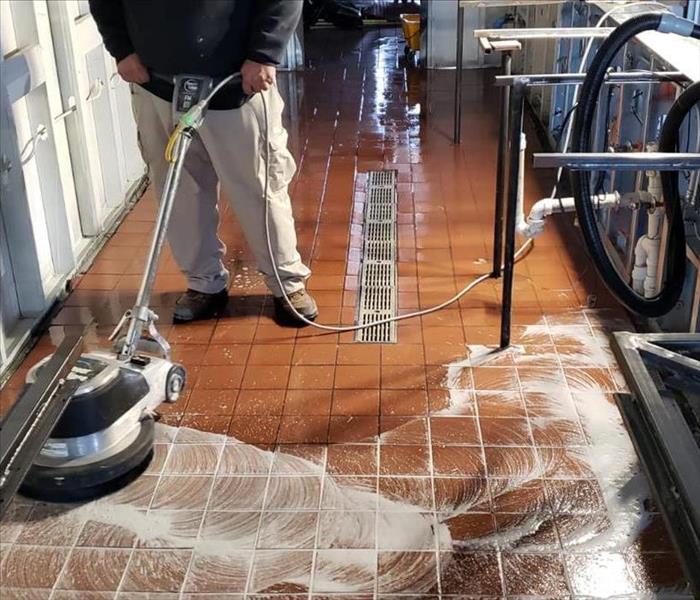 Flooring being cleaned and Waxed with cleaning machine 