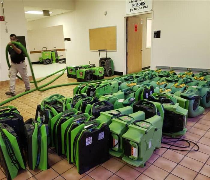 green SERVPRO equipment lining the floor