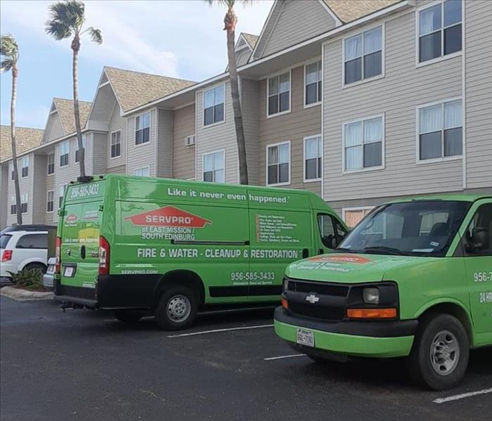 Green SERVPRO Trucks Parked Outside Customers Home